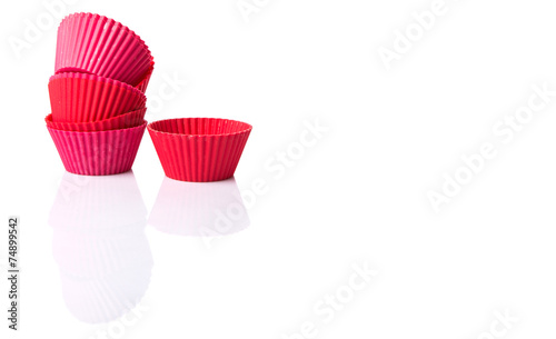 Red silicone cupcake baking cups over white background 