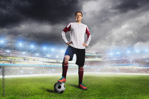 Football player with ball on field of stadium © Fotokvadrat