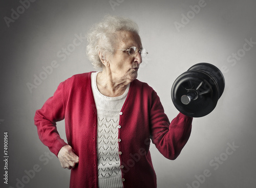 Senior woman exercising with barbells