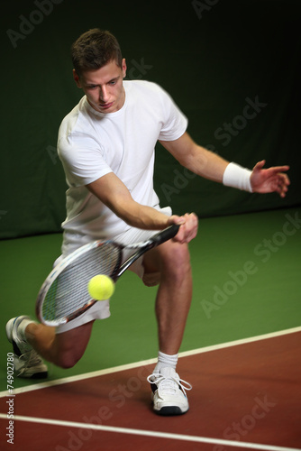 Young man playing tennis © Mikael Damkier