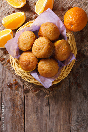 Schilderij op canvas Citrus muffins and fresh oranges close-up. Vertical top view