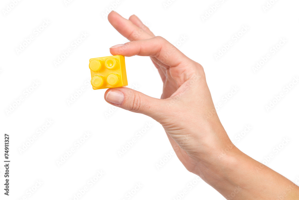 Yellow block in woman's hand