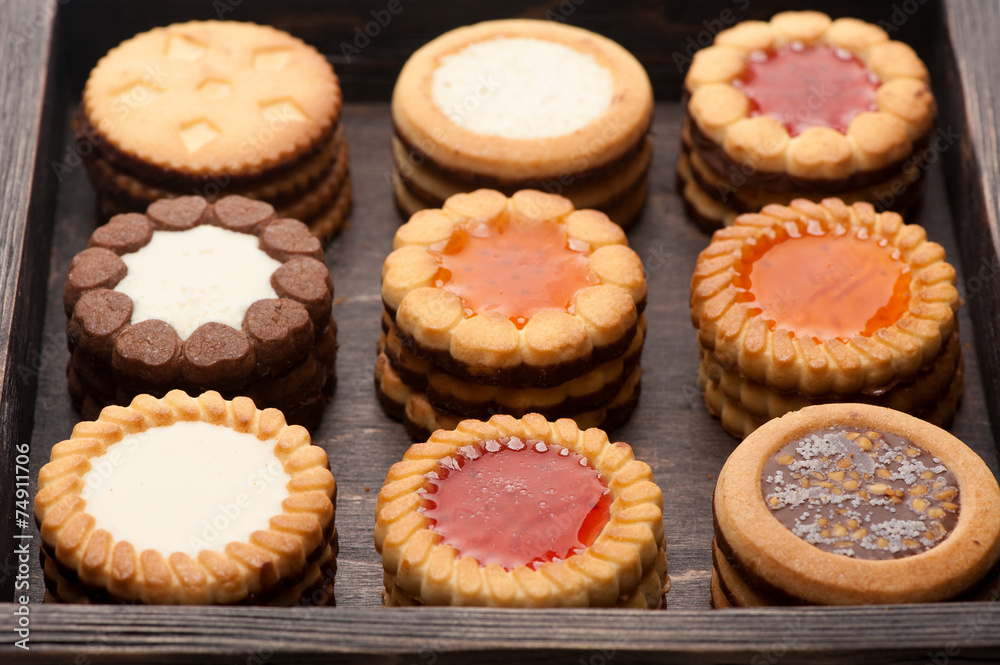 Сookies with chocolate and jam in a wooden box close-up Сookies with chocolate and jam in a wooden box close-up
