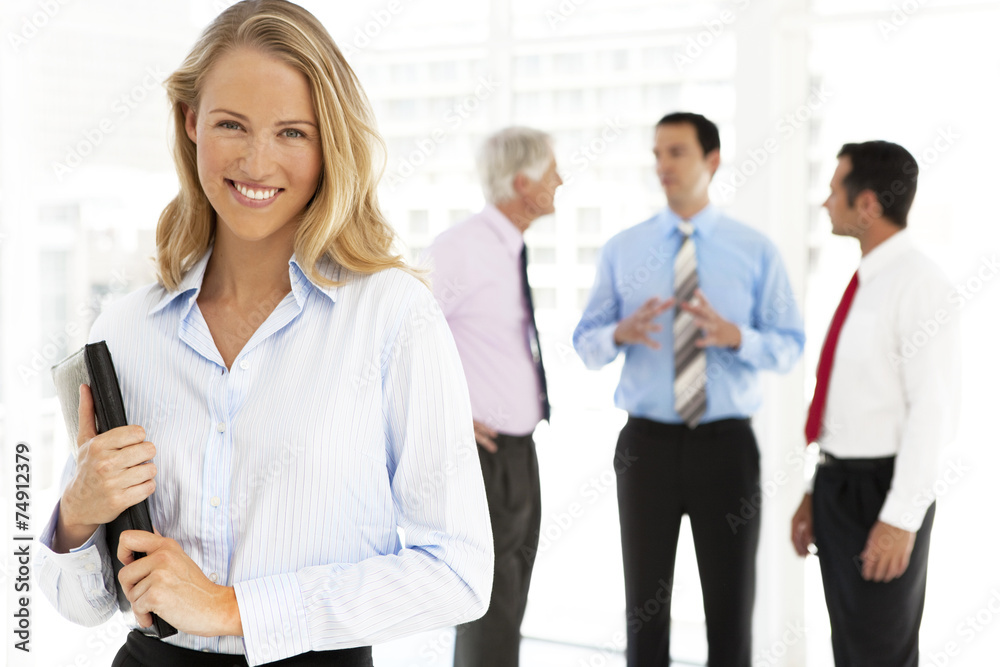 Portrait of a young businesswoman with partners on background Portrait of a young businesswoman with partners on background