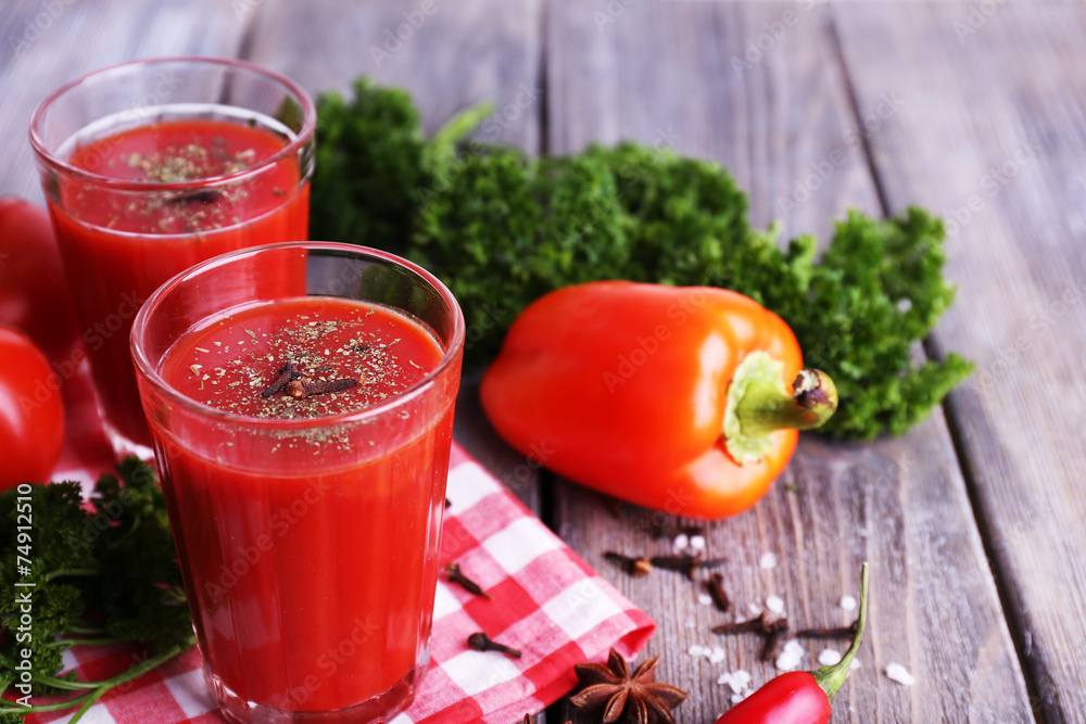 Tomato juice in glasses and fresh vegetables Tomato juice in glasses and fresh vegetables