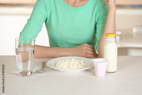 Girl and dietary food at table close-up
