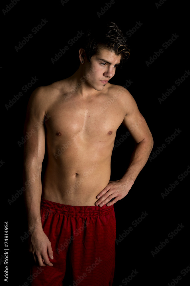 Fototapeta premium man no shirt red shorts stand on black hand hip