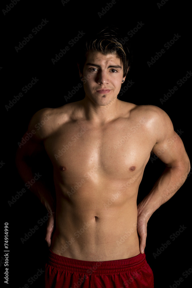 man no shirt red shorts stand on black looking man no shirt red shorts stand on black looking