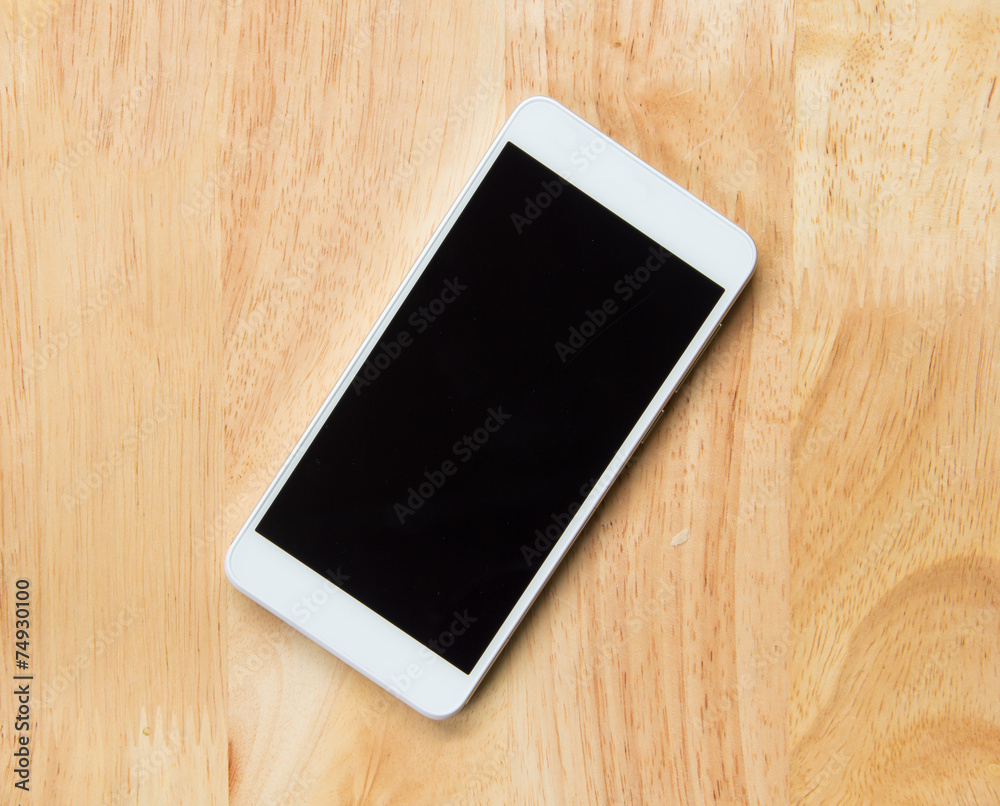 A white Smart phone on the wooden table A white Smart phone on the wooden table