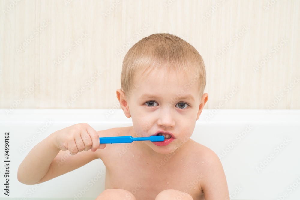 Little boy brushing his teeth blue brush in the bath Little boy brushing his teeth blue brush in the bath