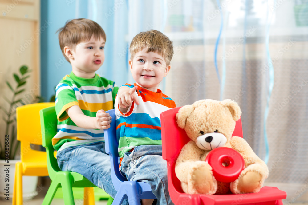 Two little boys playing role game in daycare