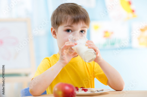 child drinking healthy beverage at home