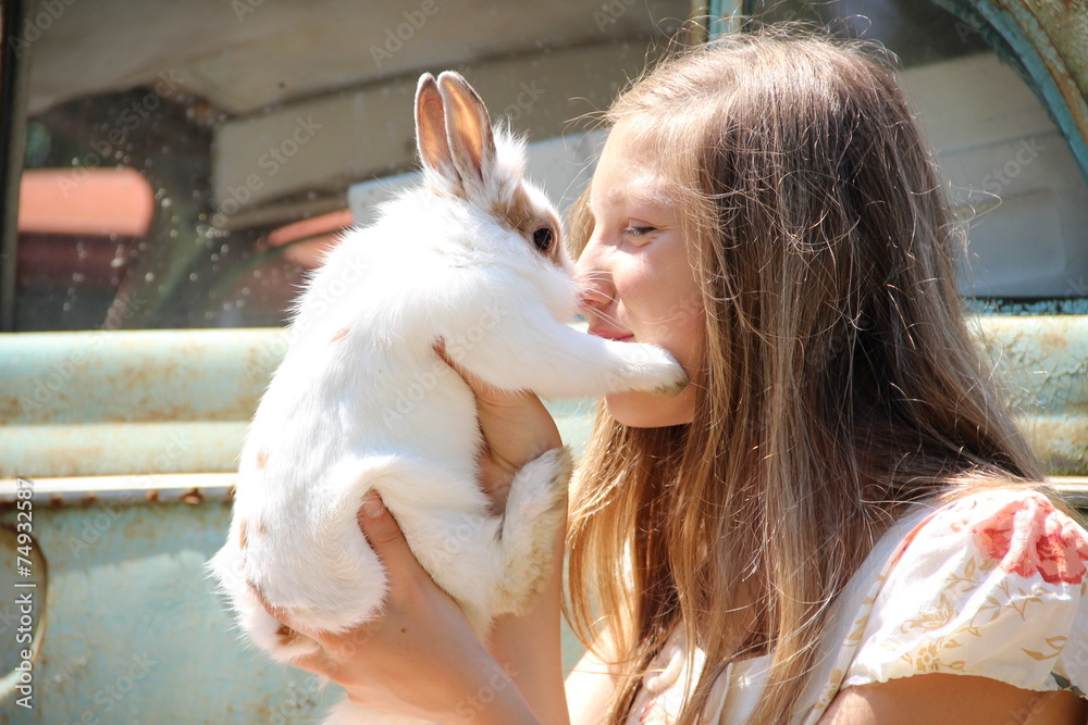 country girl playing with a rabbit country girl playing with a rabbit