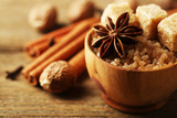 Christmas spices and baking ingredients on wooden background