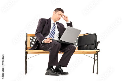 Upset businessman working on a laptop