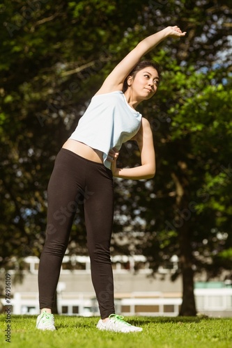 Healthy woman doing stretching exercises in park © WavebreakMediaMicro