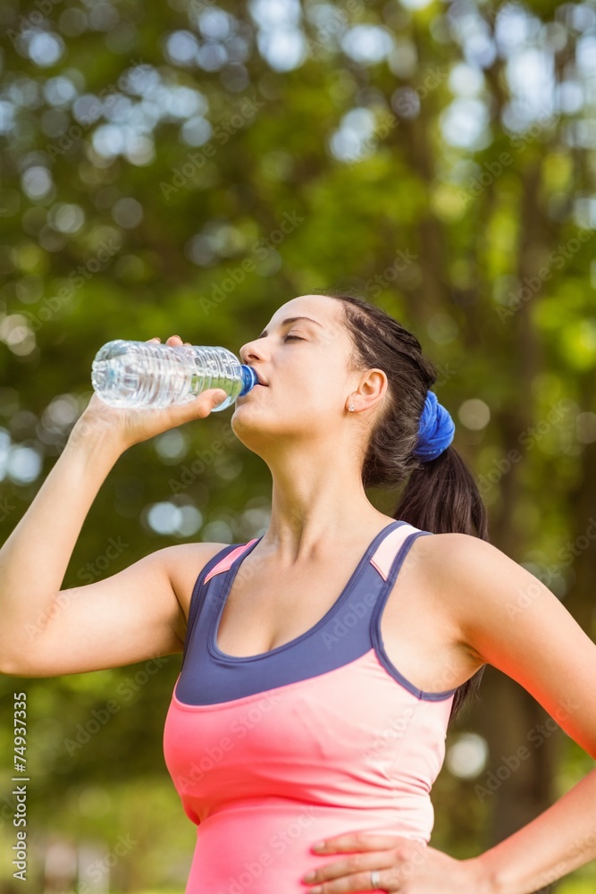 Fit brown hair drinking from her water bottle Fit brown hair drinking from her water bottle