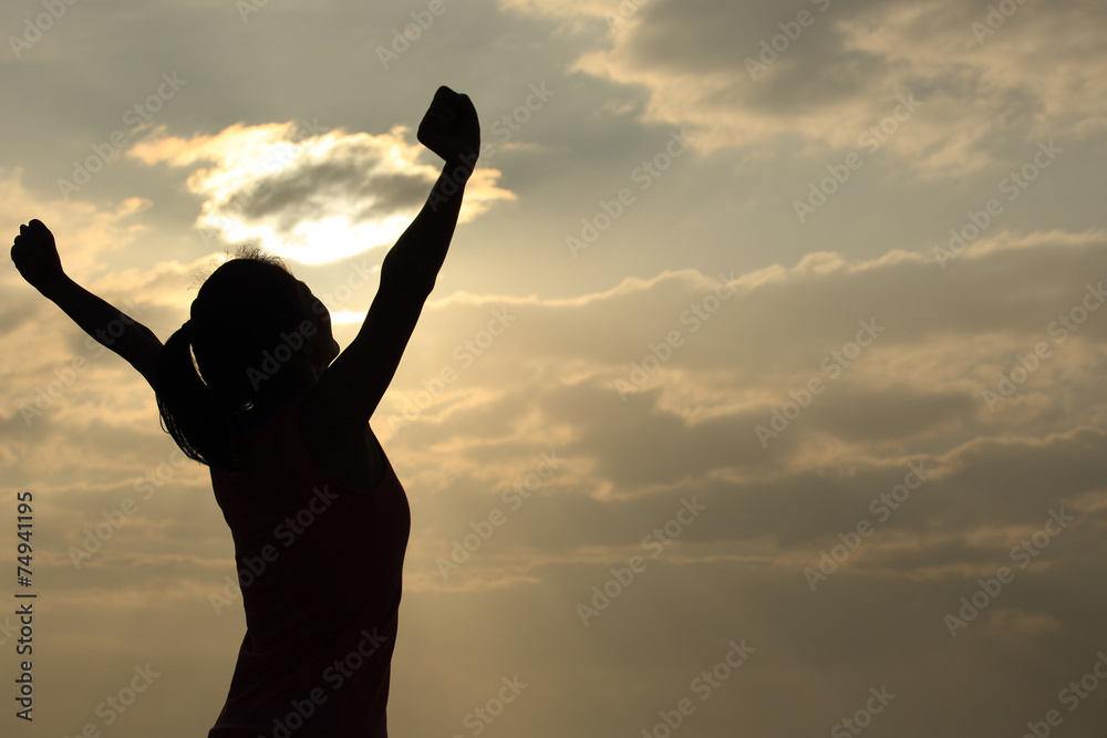Fototapeta premium strong confidence woman open arms under the sunrise at seaside 
