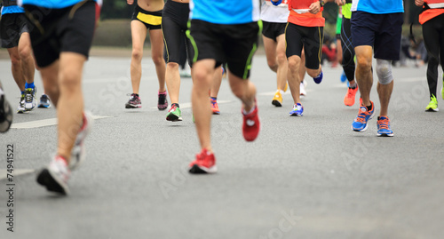 marathon athletes legs running on city road  © lzf