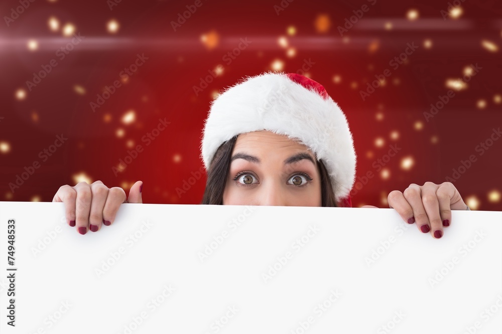 Composite image of festive brunette showing white poster Composite image of festive brunette showing white poster