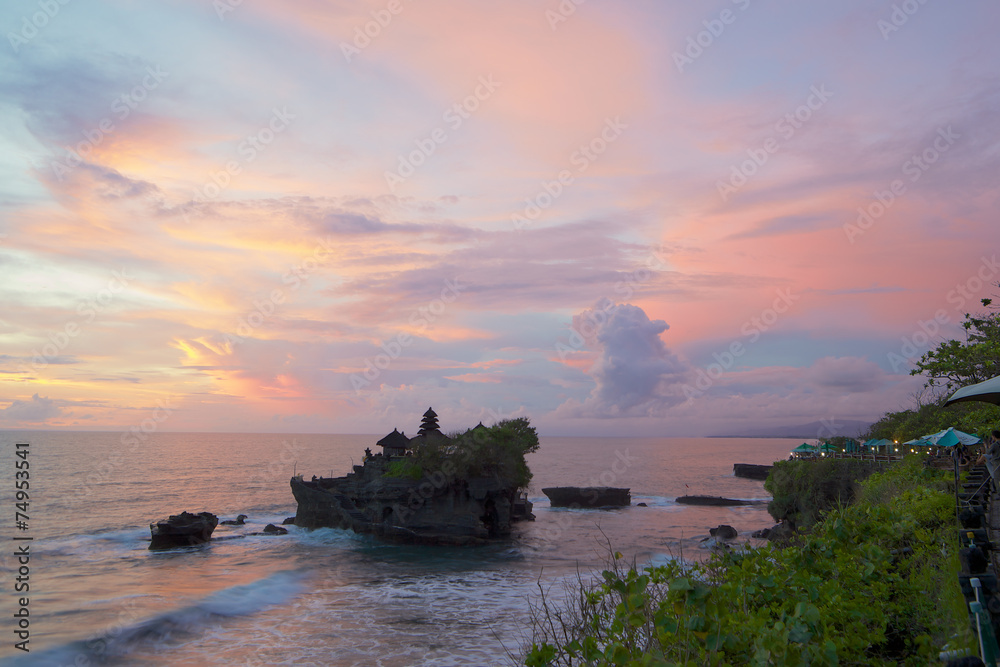 Sunset view of the temple Pura Tanah Lot from the coastal cafe