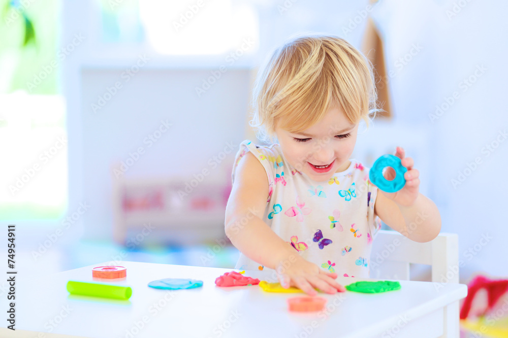 Preschooler girl playing with plasticine Preschooler girl playing with plasticine