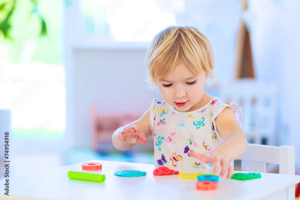 Preschooler girl playing with plasticine Preschooler girl playing with plasticine