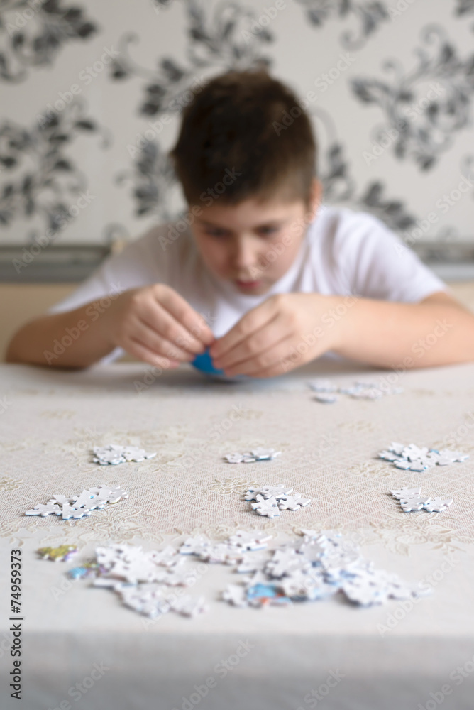 Teenager boy collects puzzles from Globe Teenager boy collects puzzles from Globe