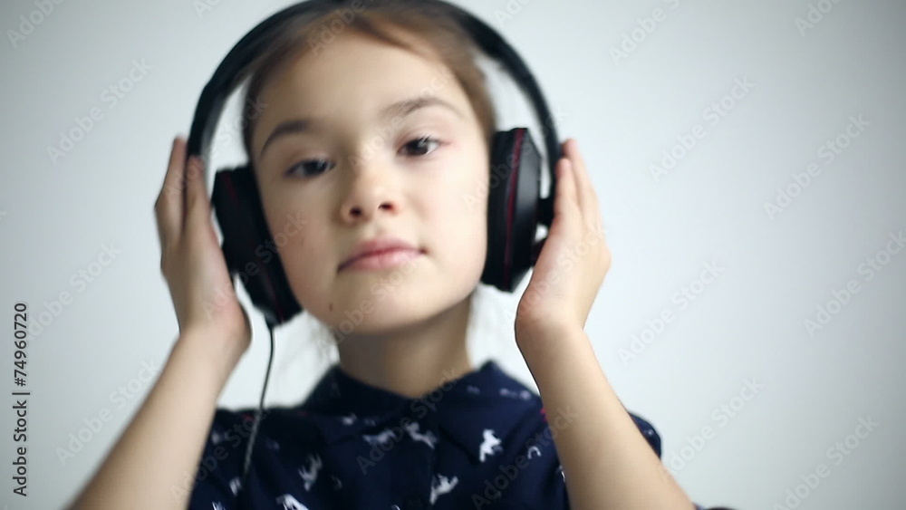 Child with headphones dancing at studio background Child with headphones dancing at studio background