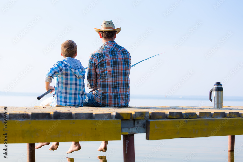 boy and his father fishing togethe boy and his father fishing togethe