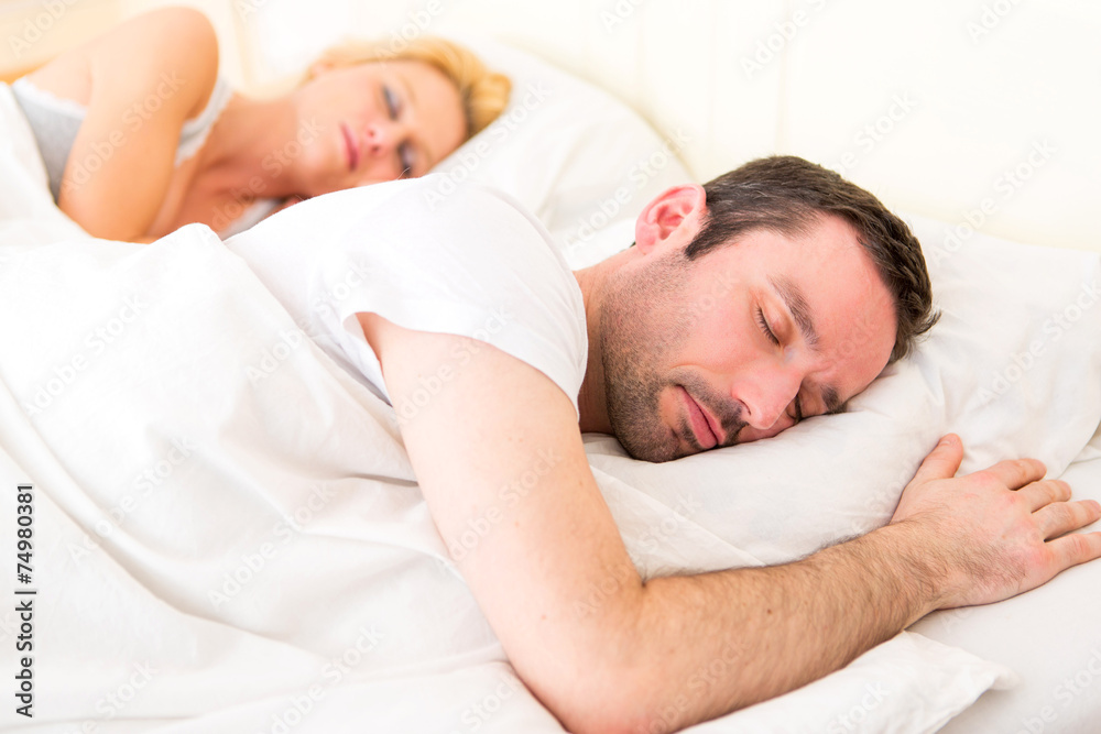 Young attractive couple sleeping in a bed Young attractive couple sleeping in a bed