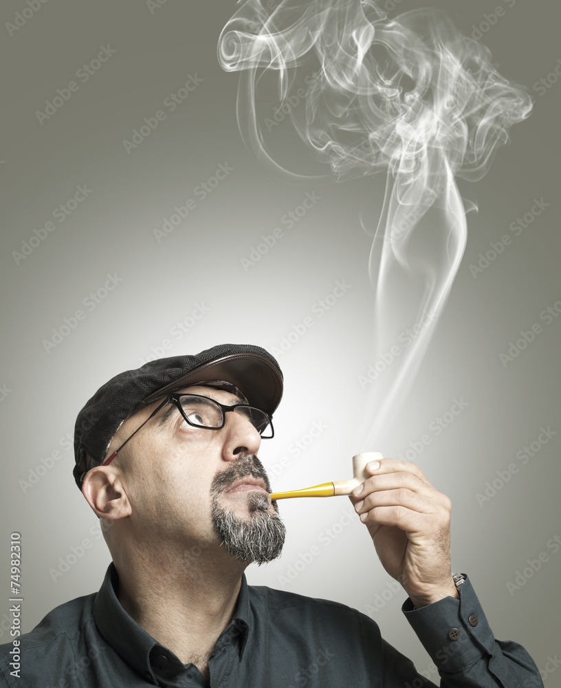 Fototapeta premium The man smokes a pipe