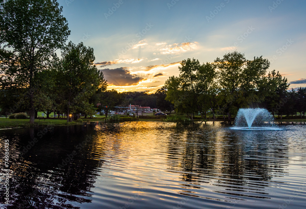 Sunset over fountain pond in Luray, Virginia.