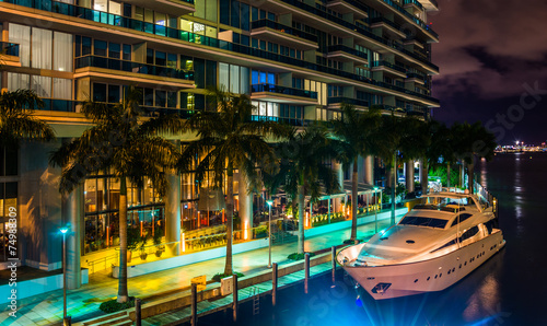 The Epic Hotel and a boat in the Miami River at night, in downto