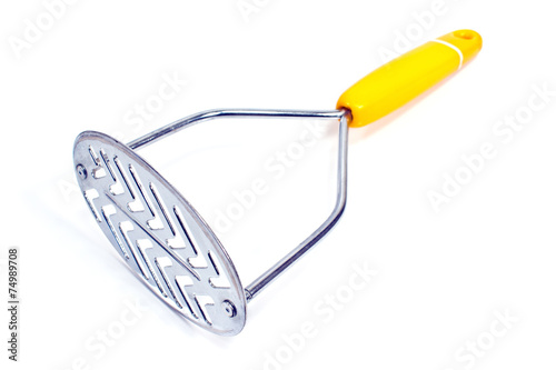 Yellow potato masher isolated on white photo