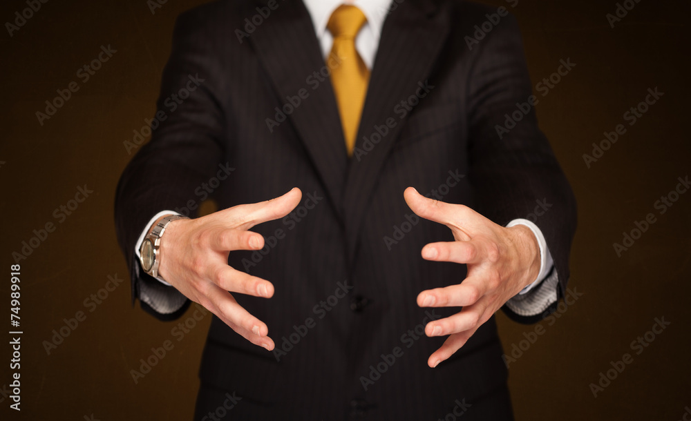 Obraz premium Businessman holding something