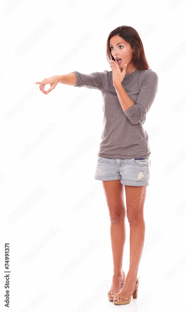 Lovely female in shorts standing up pointing Lovely female in shorts standing up pointing