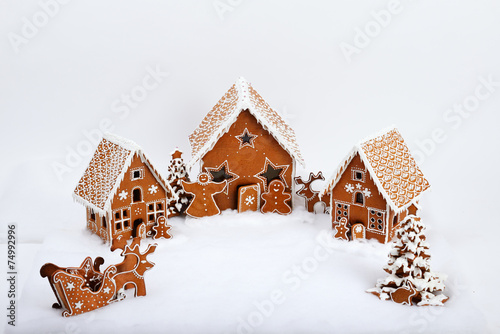 The family near hand-made eatable gingerbread house and New Year