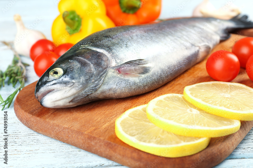 Fresh raw fish and food ingredients on table Fresh raw fish and food ingredients on table