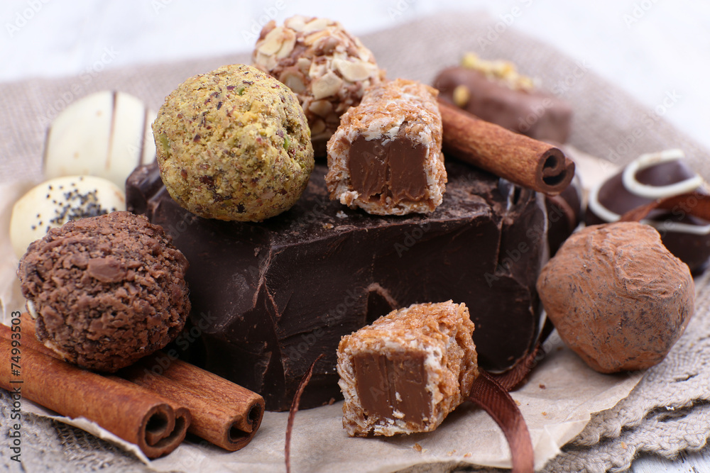 Pile of chunk of chocolate and truffles with cinnamon stick