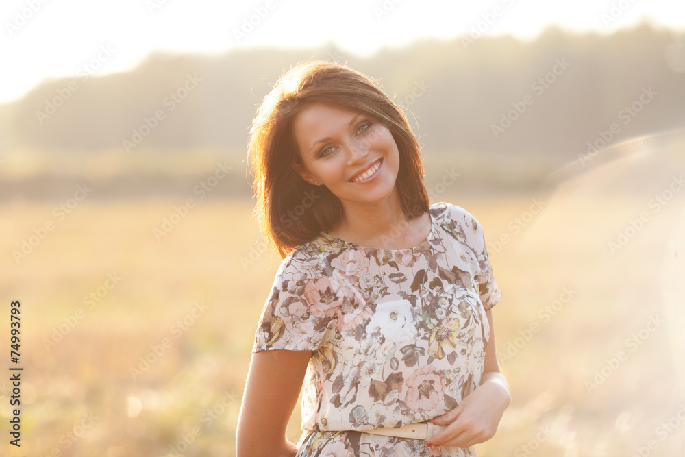Sunny summer portrait of a beautiful smiling young woman Sunny summer portrait of a beautiful smiling young woman