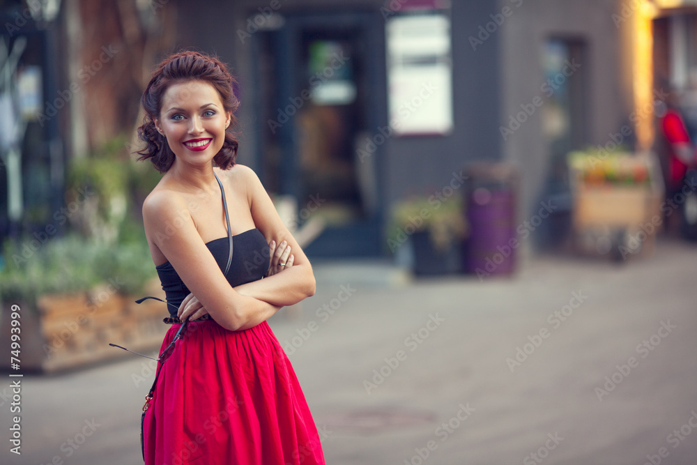 Summer street portrait of a beautiful young Caucasian girl