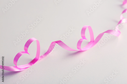Ribbon shaped as heart on gray background © Africa Studio