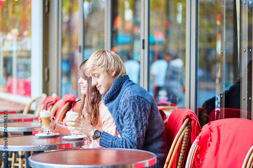Dating couple drinking coffee in a Parisian cafe Dating couple drinking coffee in a Parisian cafe