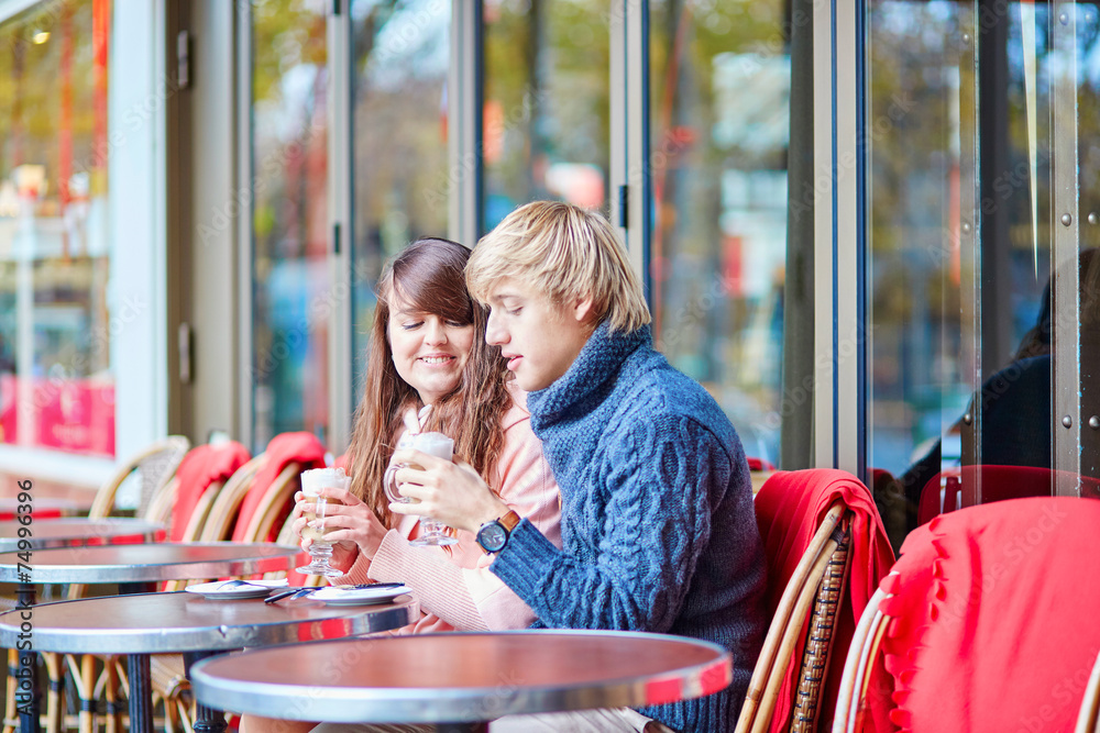 Dating couple drinking coffee in a Parisian cafe Dating couple drinking coffee in a Parisian cafe