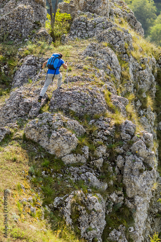 Young man hiking on the mou...