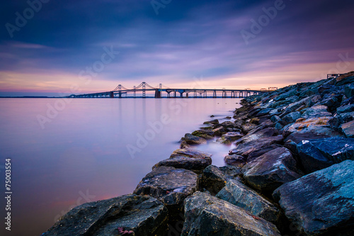 Fototapeta Long exposure of a jetty and the Chesapeake Bay Bridge, from San