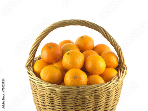 Tangerines in brown wicker basket isolated on white