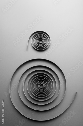Two abstract metallic spirals
