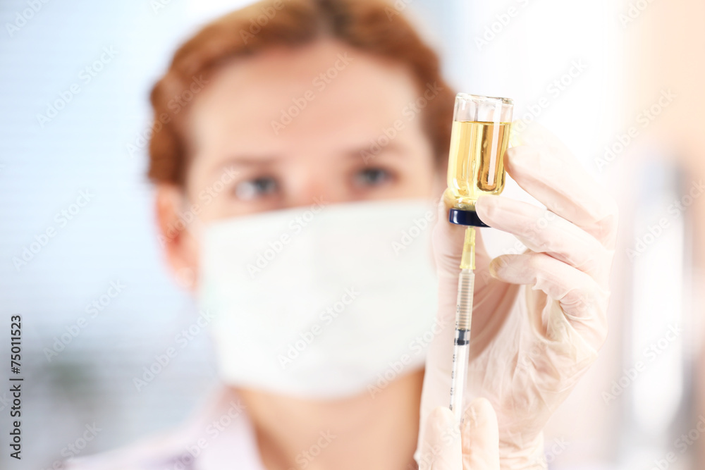 Doctor with medical syringe in hands, getting ready for Doctor with medical syringe in hands, getting ready for